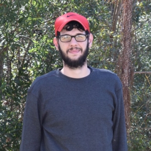 Nathan with red hat, dark shot and glasses